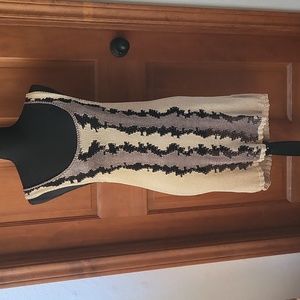 Knit dress with tan, black and brown design on front.